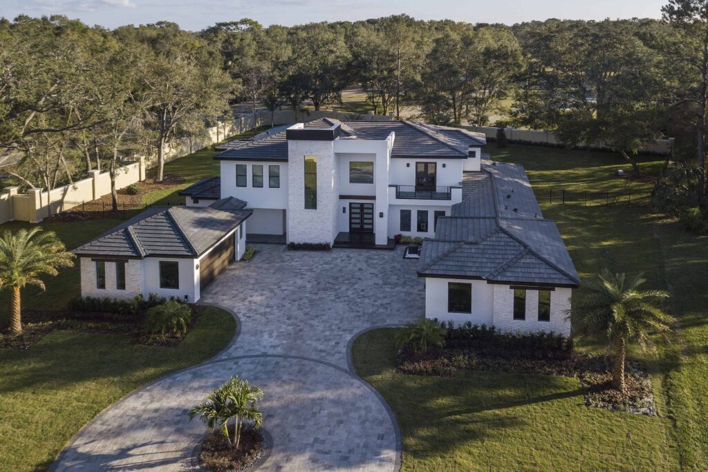 An aerial view of The Design Tourist's personal residence, a Florida Modern home. Notice the subtle pitches in the roofline that are designed to appear planar from the facade and ground level. The home was designed and built by Orlando Custom Home Builder Jorge Ulibarri www.ImYourBuilder.com