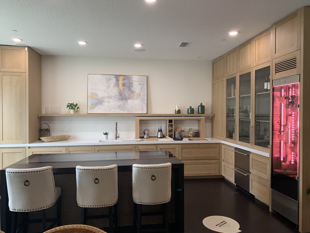 Wellness Kitchen in Whit features a GE Innovative Cooktop embedded in the kitchen island that lets you cook and connect in one intelligent surface. Photo Credit: The Design Tourist 