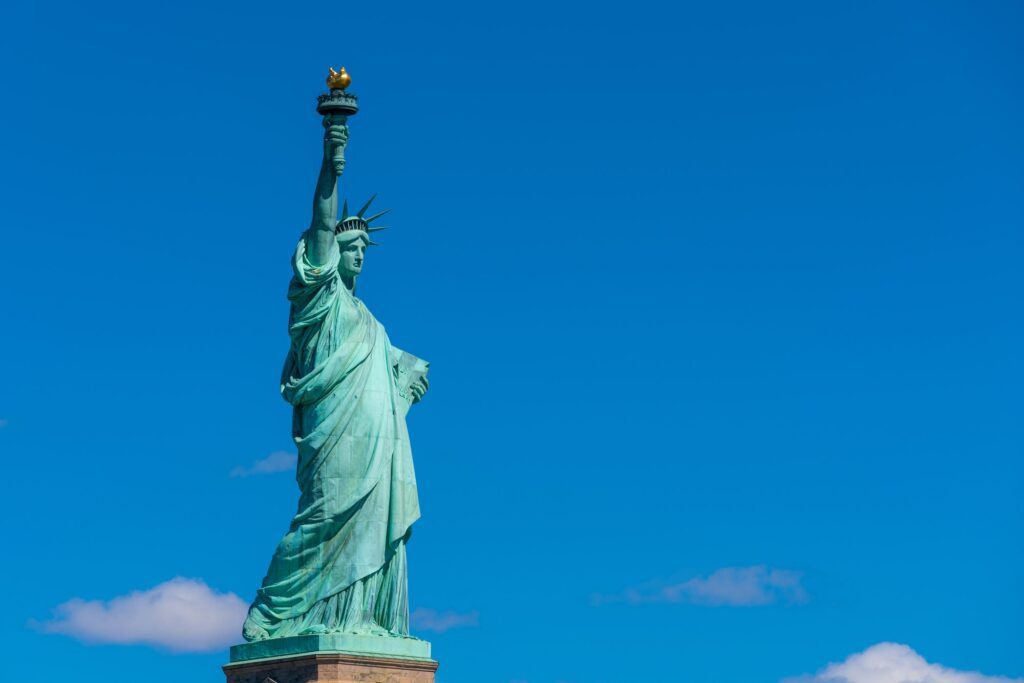 The Statue of Liberty under the blue sky background, Lower Manhattan, New York City,