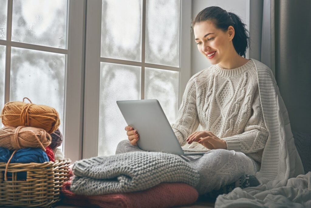 woman sitting near windows