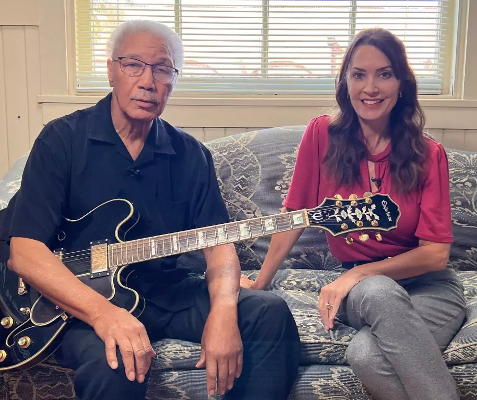 Y.Z. Ealey holding an electric guitar with Karen LeBlanc.