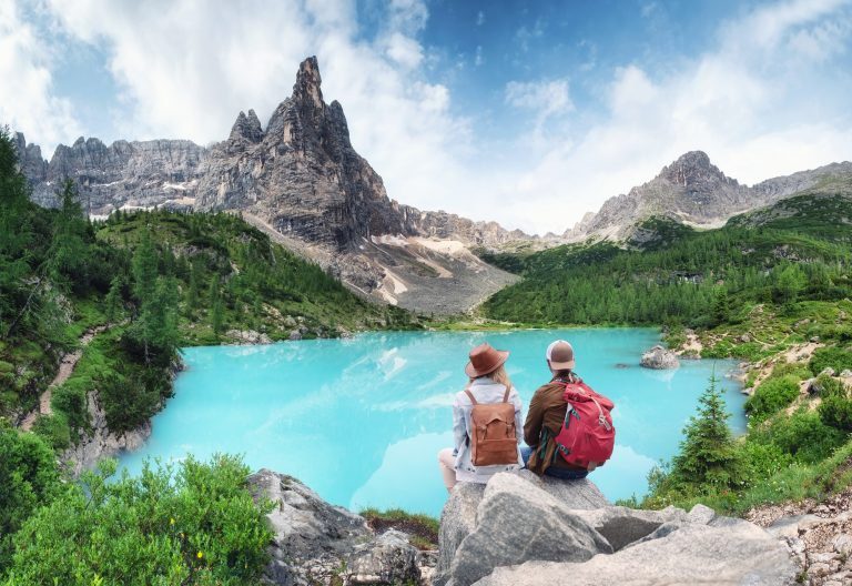 Tourist and Sorapis lake in the Italy. Travel and adventure with team