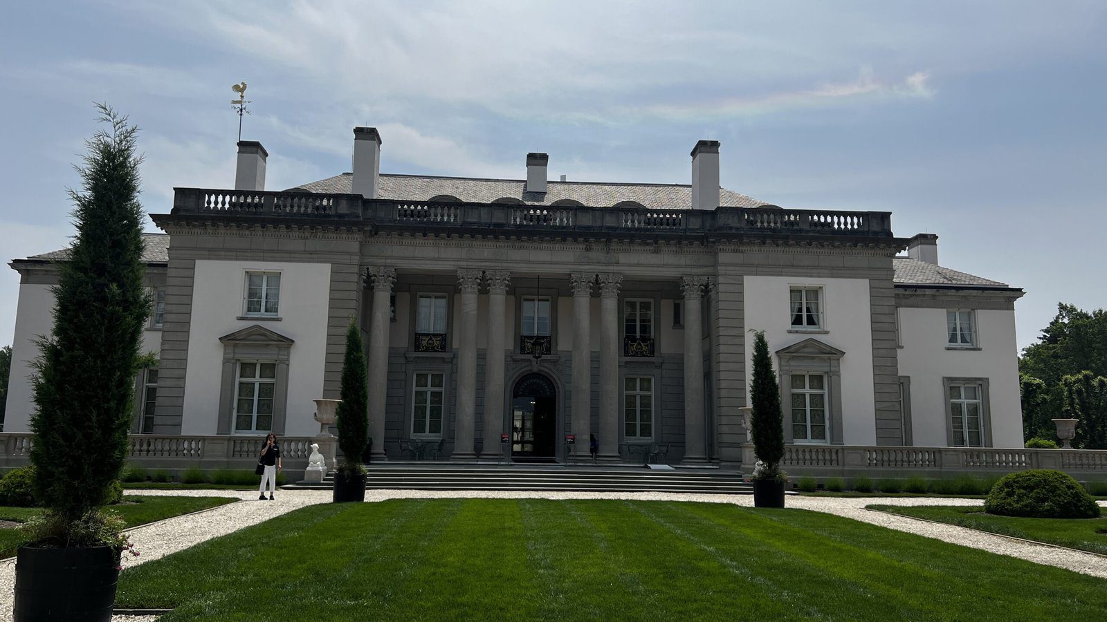 Front view of the grand neoclassical façade of Nemours Estate with columned entrance and manicured lawn