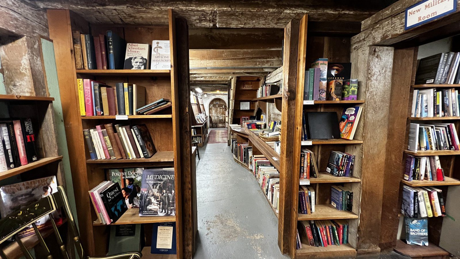 Cozy wooden hallway inside Baldwin’s Book Barn, lined with shelves of old and new titles, capturing the historic charm of Brandywine Valley’s best bookstores.