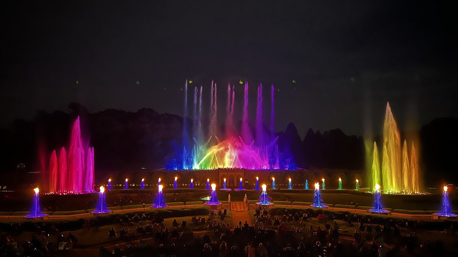 Nighttime light and water show during the Festival of Fountains at Longwood Gardens with a rainbow of illuminated jets