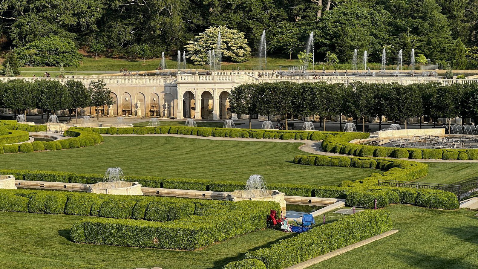 Elevated view of the Main Fountain Garden at Longwood with symmetrical hedges, trimmed lawns, and active water fountains