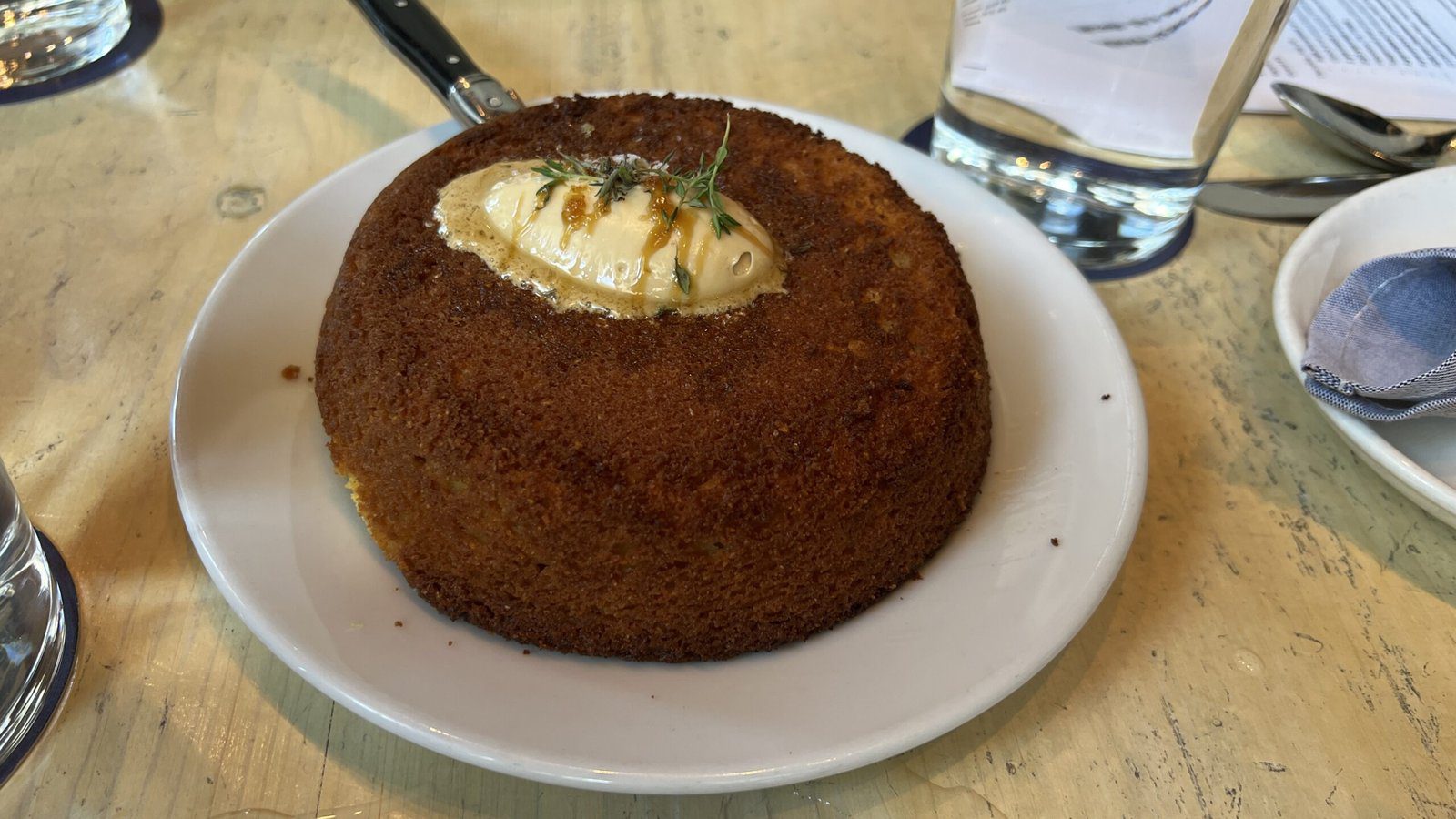 Golden cast-iron cornbread at Eunice topped with whipped butter and herbs.