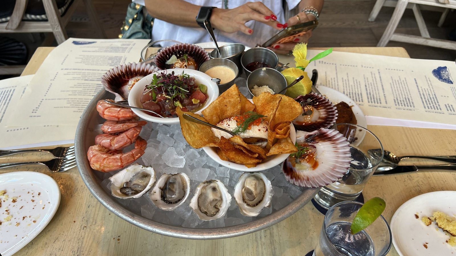 Gulf Coast seafood platter at Eunice with oysters, shrimp, scallops, ceviche, and dipping sauces served on ice.