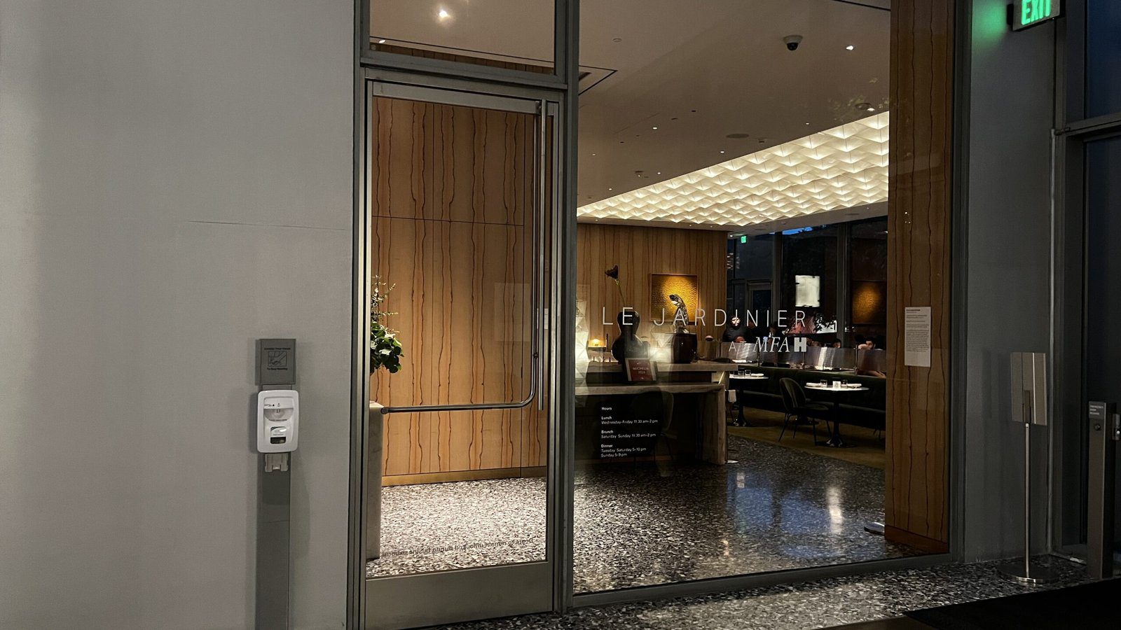 Exterior view of Le Jardinier restaurant inside the Museum of Fine Arts Houston, with modern wood and glass design.