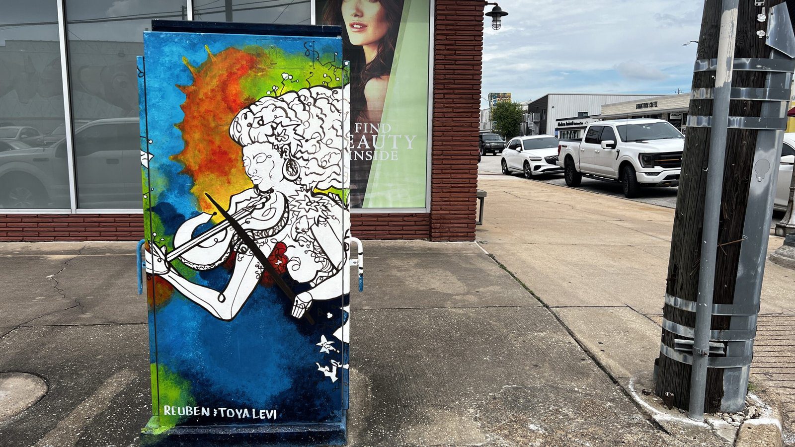 Houston mini murals turn traffic boxes into art, like this violinist design by Reuben and Toya Levi that adds color and culture to everyday street corners.