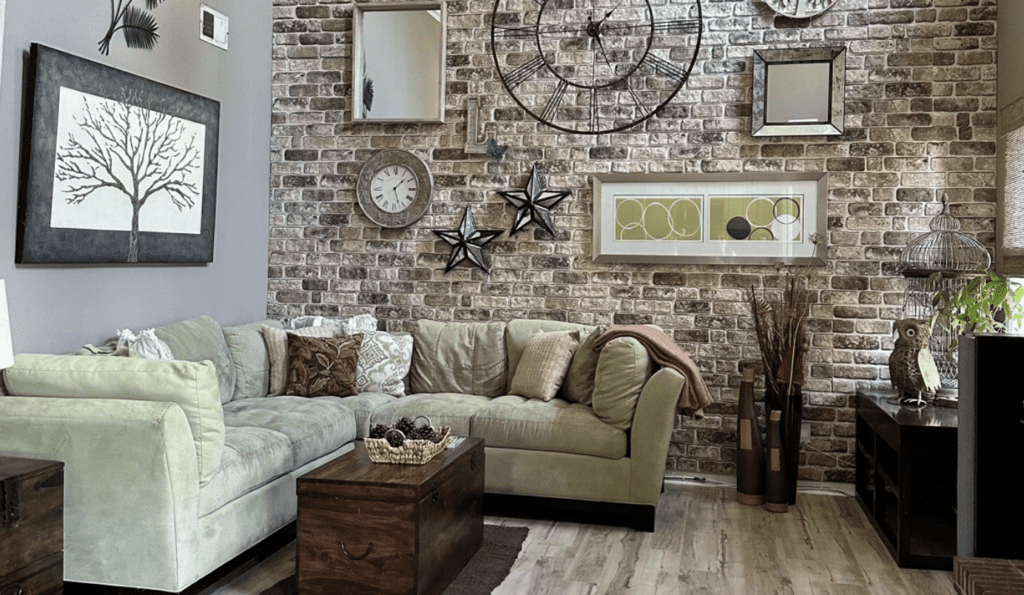 Industrial living room featuring brick accent wall and gallery decor